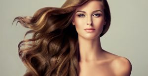 Glamorous woman with long brown hair flowing